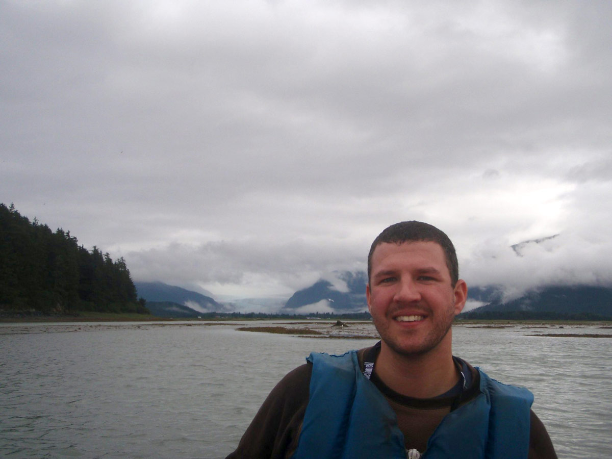 Man kayaking with a view of the Mendenhall Glacier in the background while on an Alaska cruise excursion.
