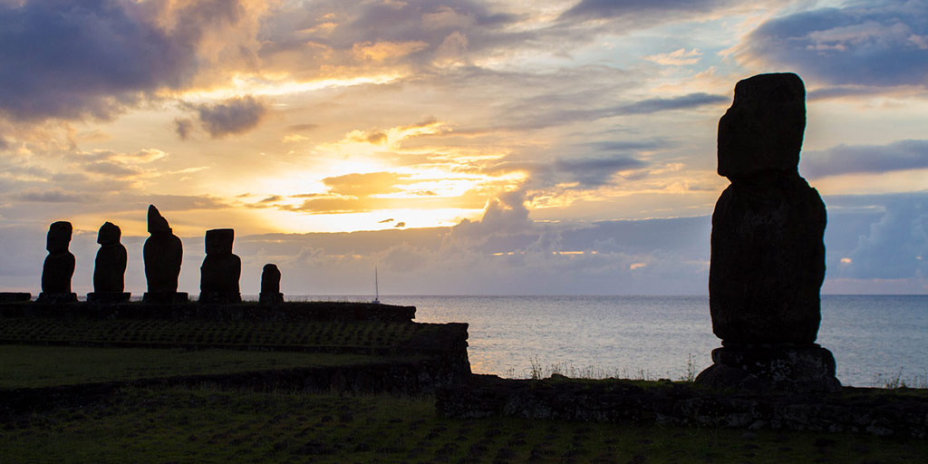 Moai are silhouetted by the setting sun on Easter Island
