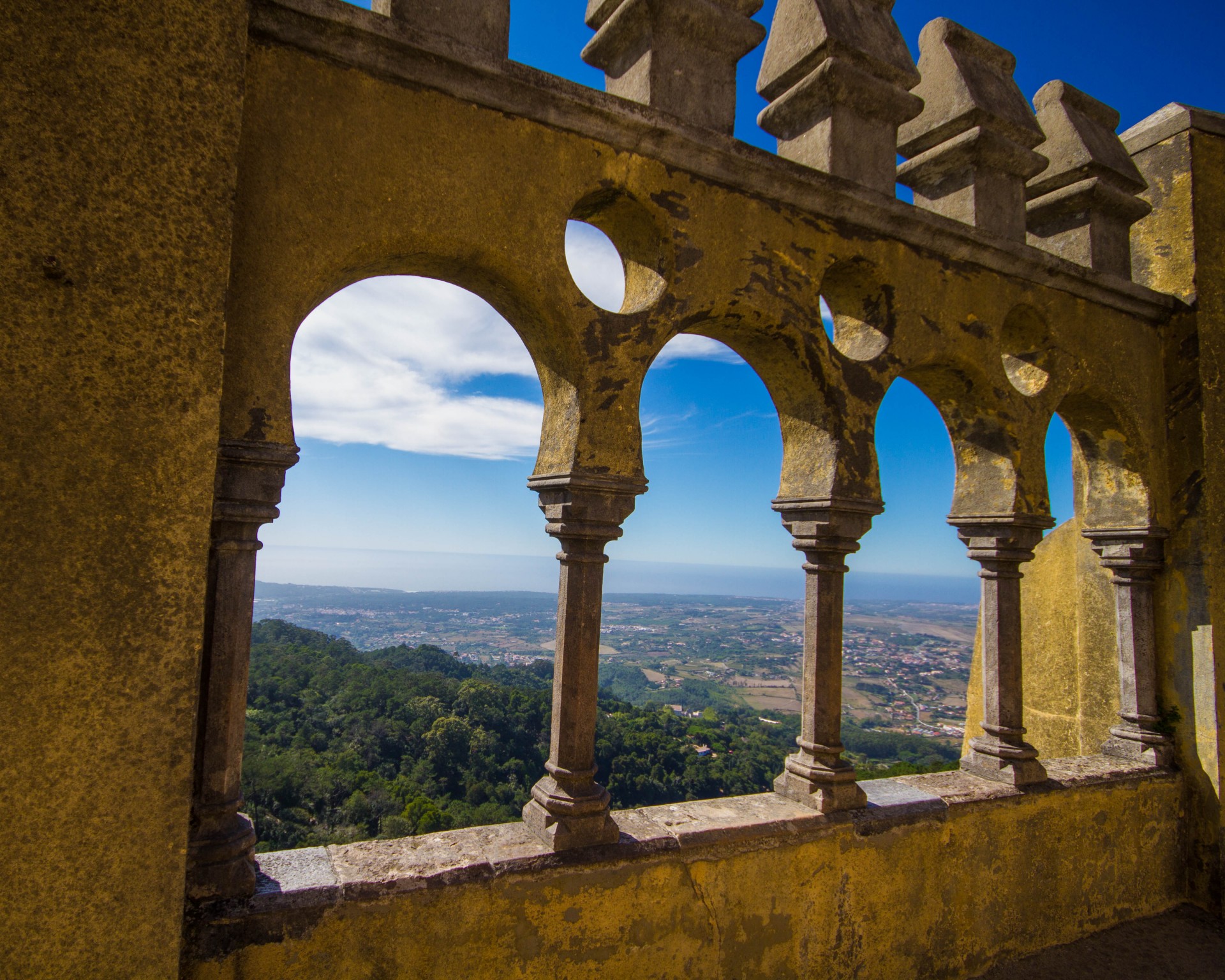 Looking out over Sintra, Portugal and it's surrounding lush forests from the detailed ramparts of Pena Palace
