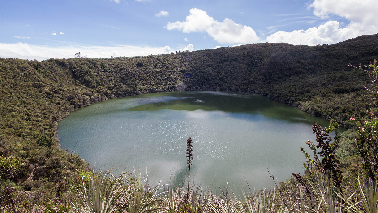 A crater lake surrounded by jungle that is believed to be part of the Lost City of Gold in Guatavita Colombia with Kids