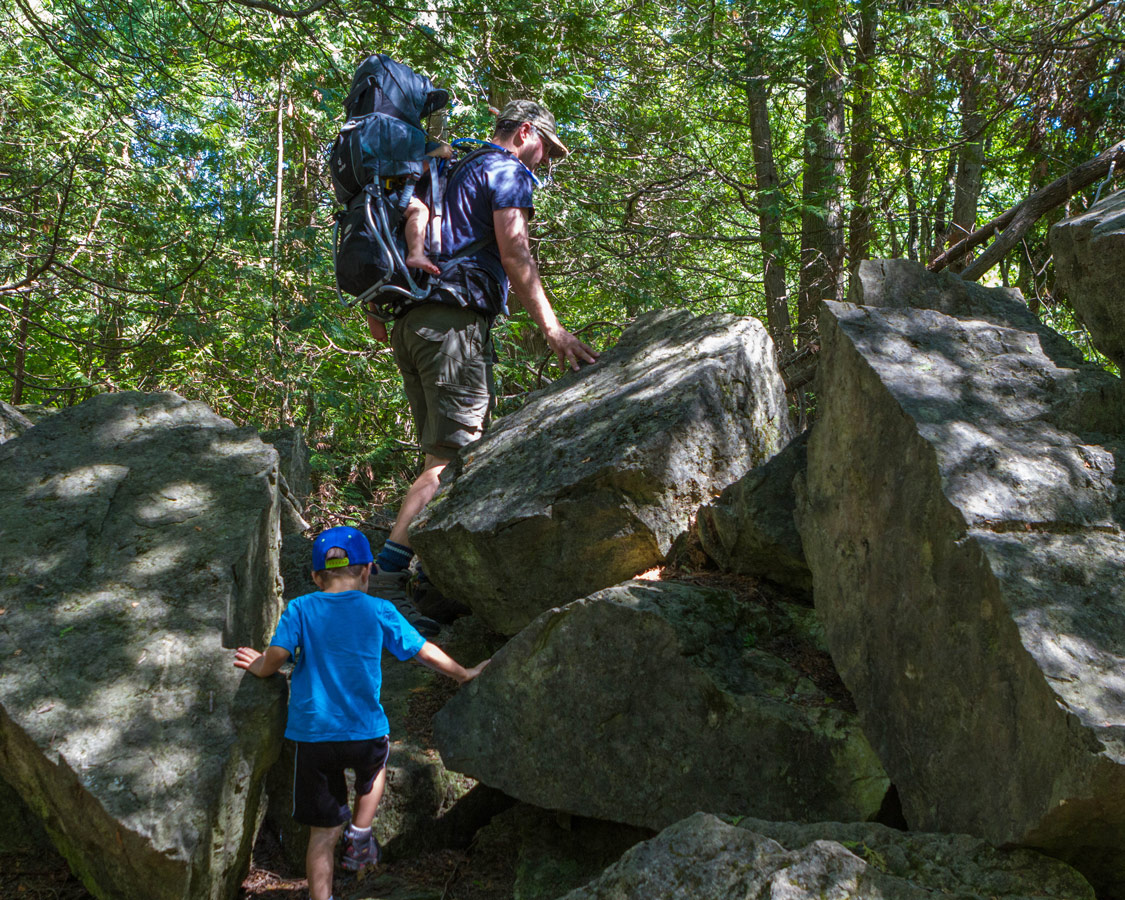 boys-climb-large-rocks-near-the-lime-kiln-at-Limehouse-Conservation-Area-in-Ontario