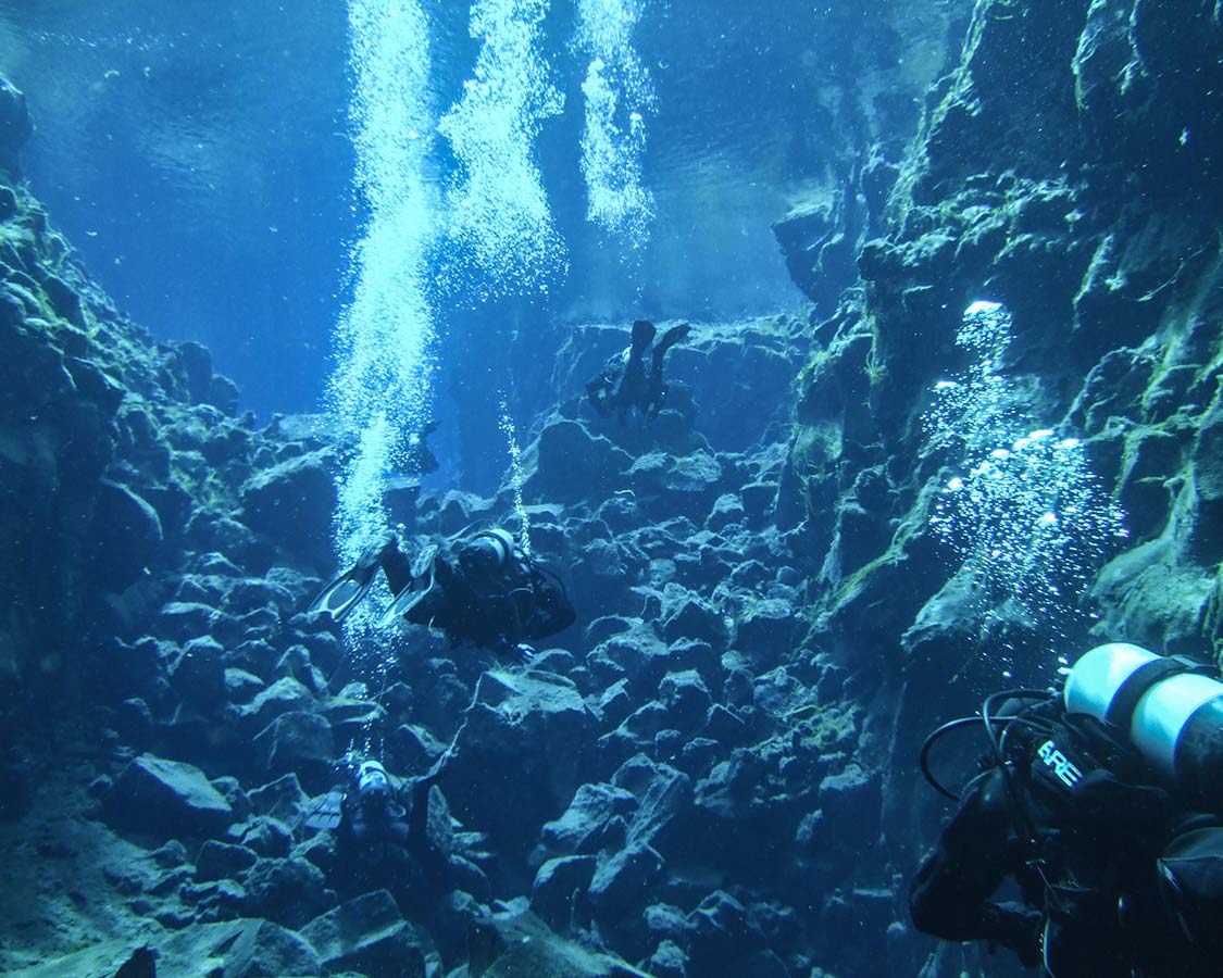 SCUBA divers in the Silfra Crack in Iceland