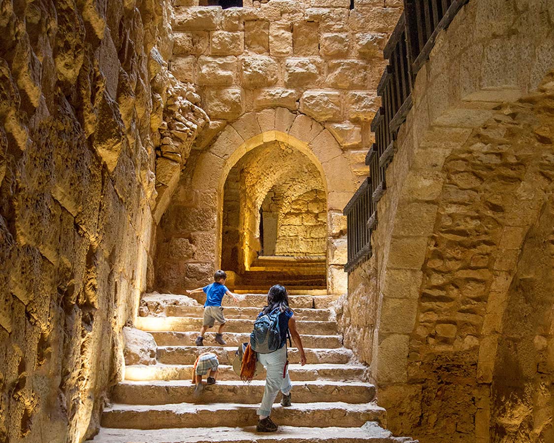 Climbing the stairs of Aljoun Castle in Jordan
