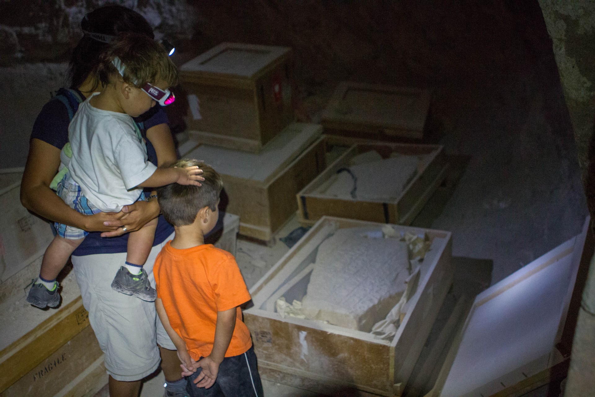 Mother and young children examine ancient artifacts in an ancient castle