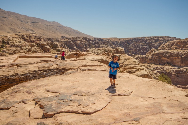 A child walks slowly on top of the High Place of Sacrifice in Petra, Jordan.