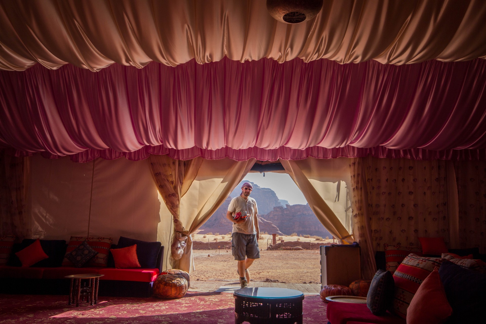 Dramatic drapery of a bedouin tent with a man standing at the entrance in the Wadi Rum Desert