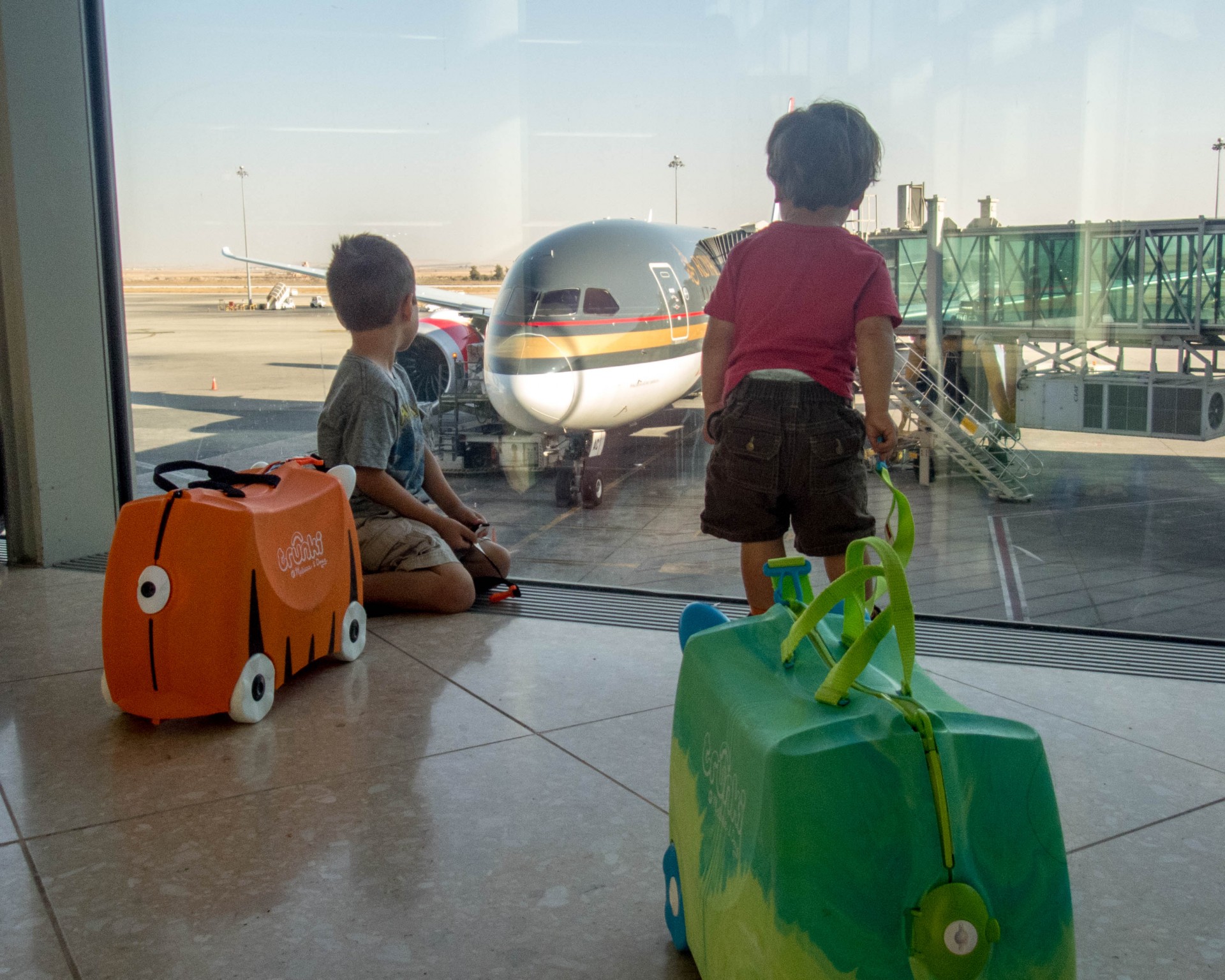 Two boys watch a Royal Jordanian plane from Toronto Pearson Airport