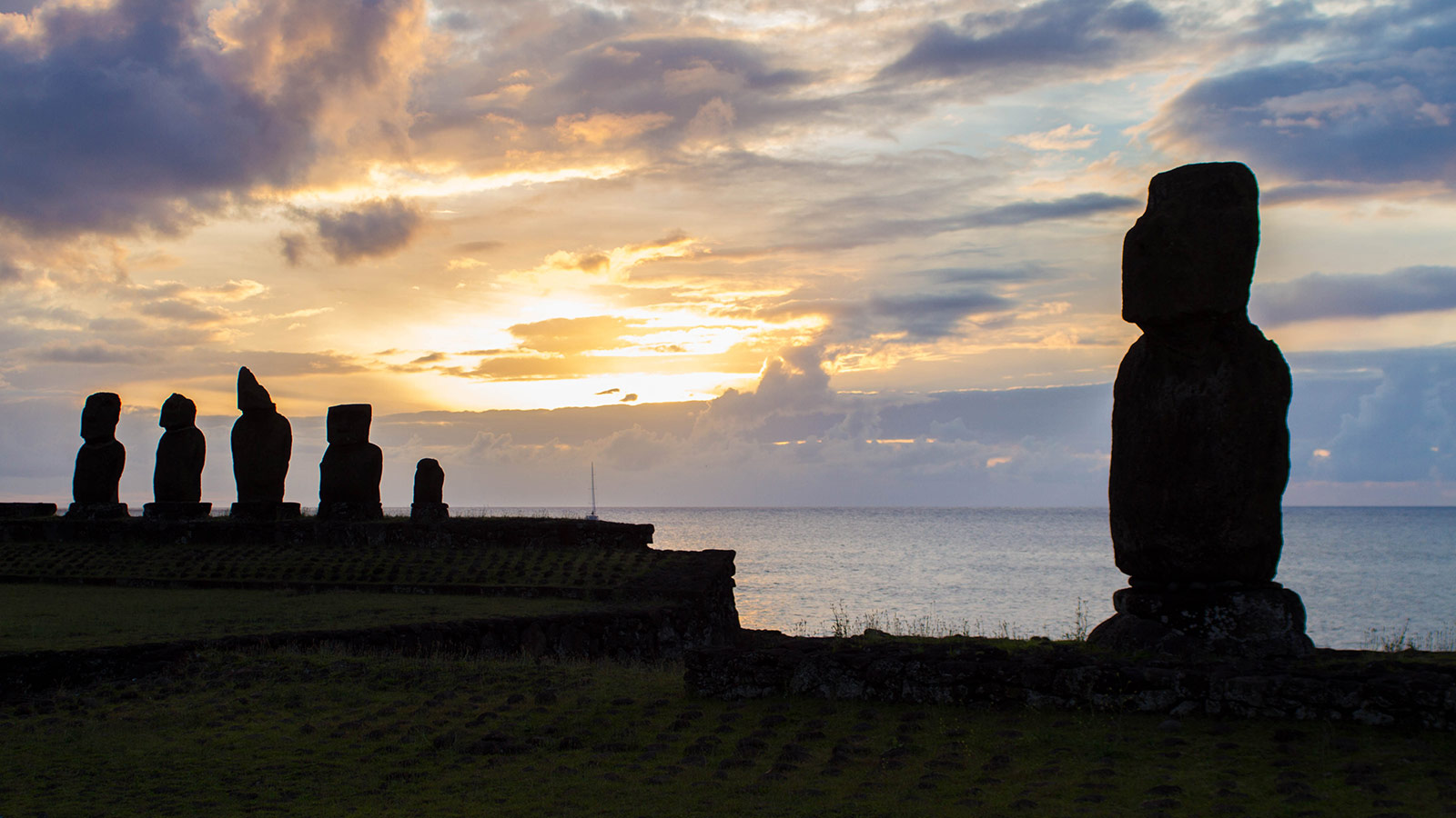 Moai are silhouetted by the sunset on Easter Island