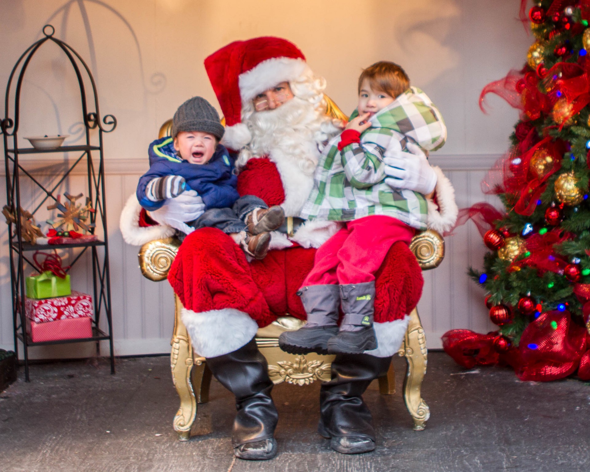 Toronto Christmas Market Santa with one happy and one not-so-happy boy on his lap