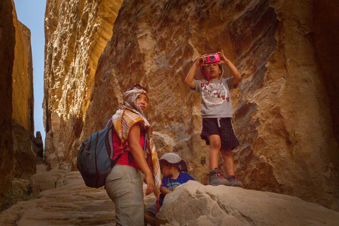 A woman and two children hiking through Little Petra in Jordan