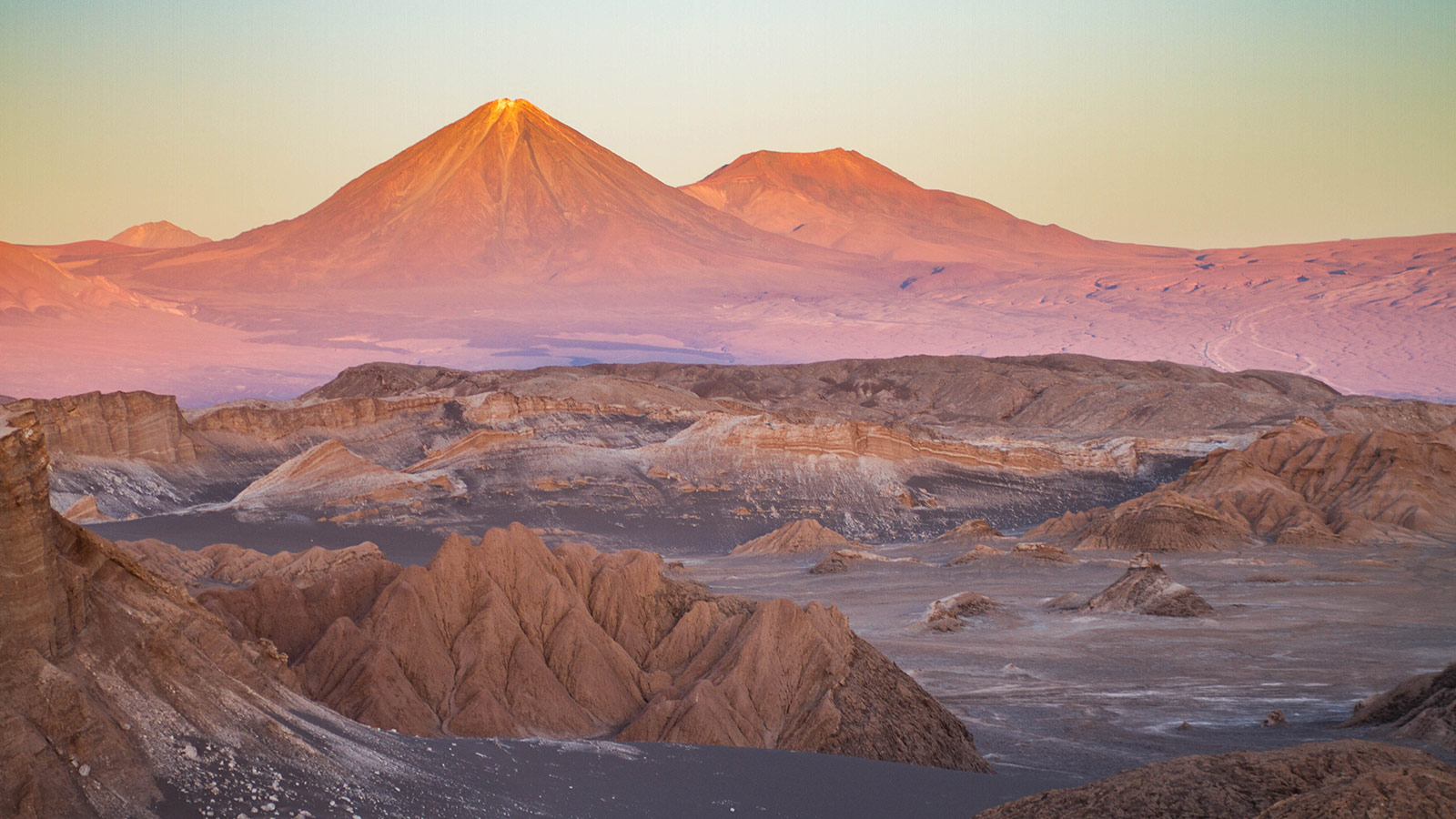 The Andes mountain act as a backdrop to the alien landscape of the Valle de la Luna in Chile