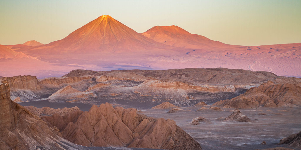 The Andes mountain act as a backdrop to the alien landscape of the Valle de la Luna in Chile
