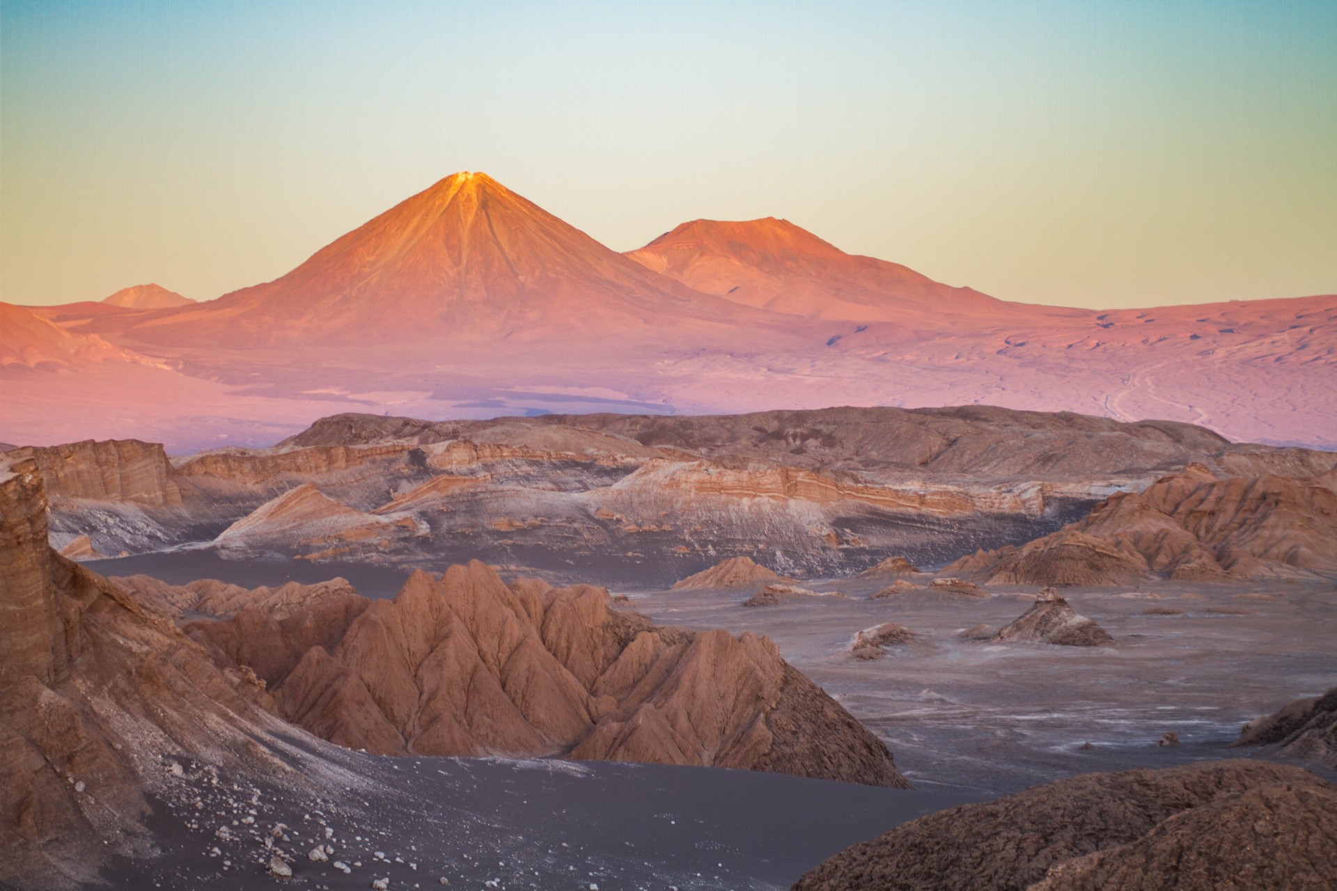 Sunset make the colours of the Atacama Desert explode with the Andes mountain range in the backdrop