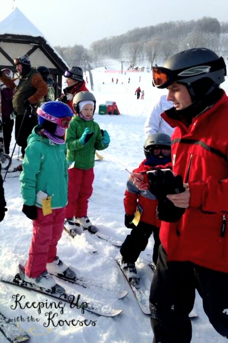 Girl gets ski lesson from an instructor - Skiing North Michigan