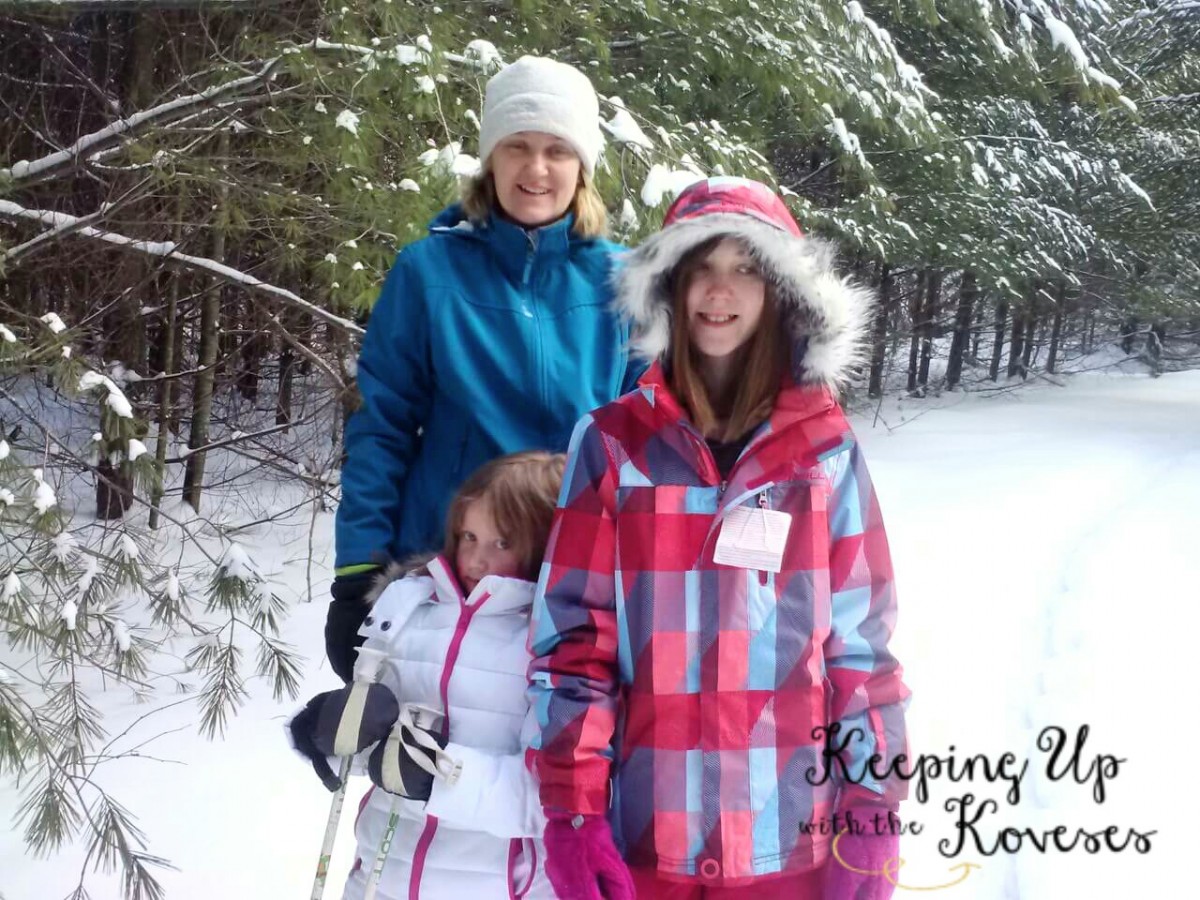 Smiling Mom and daughters in snow gear - Skiing North Michigan