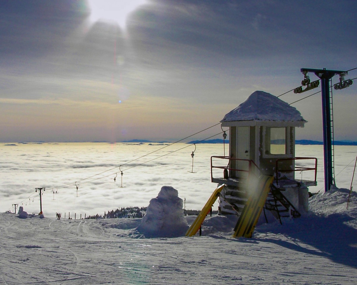 Ski lifts silhouetted by a sunset - Learning to ski at Kelowna's Big White