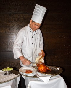 Chef carving duck at New York Peking Duck House
