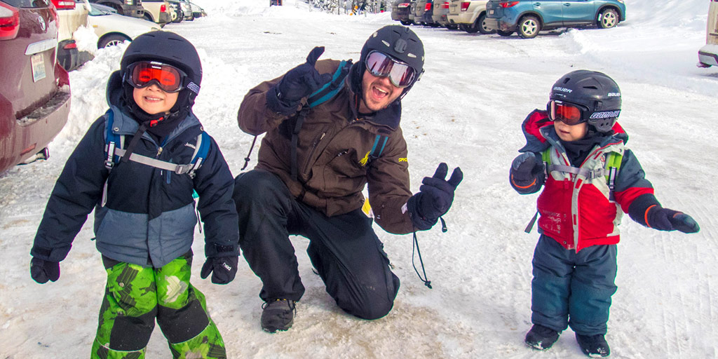 A young family in ski gear ready to hit the hills