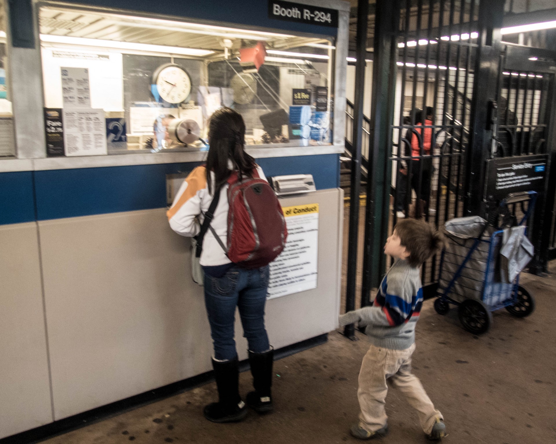 woman and children at subway ticket counter