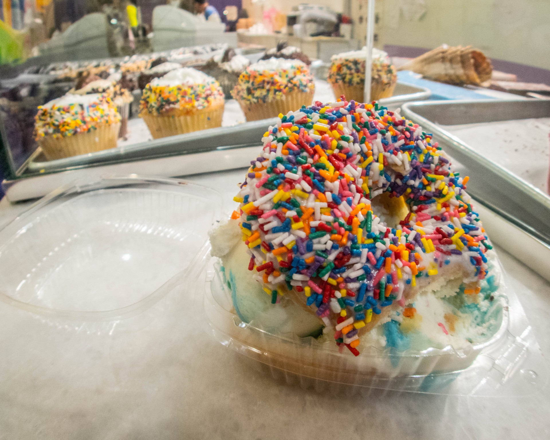 An Ice cream sandwich made out of a sprinkled donut