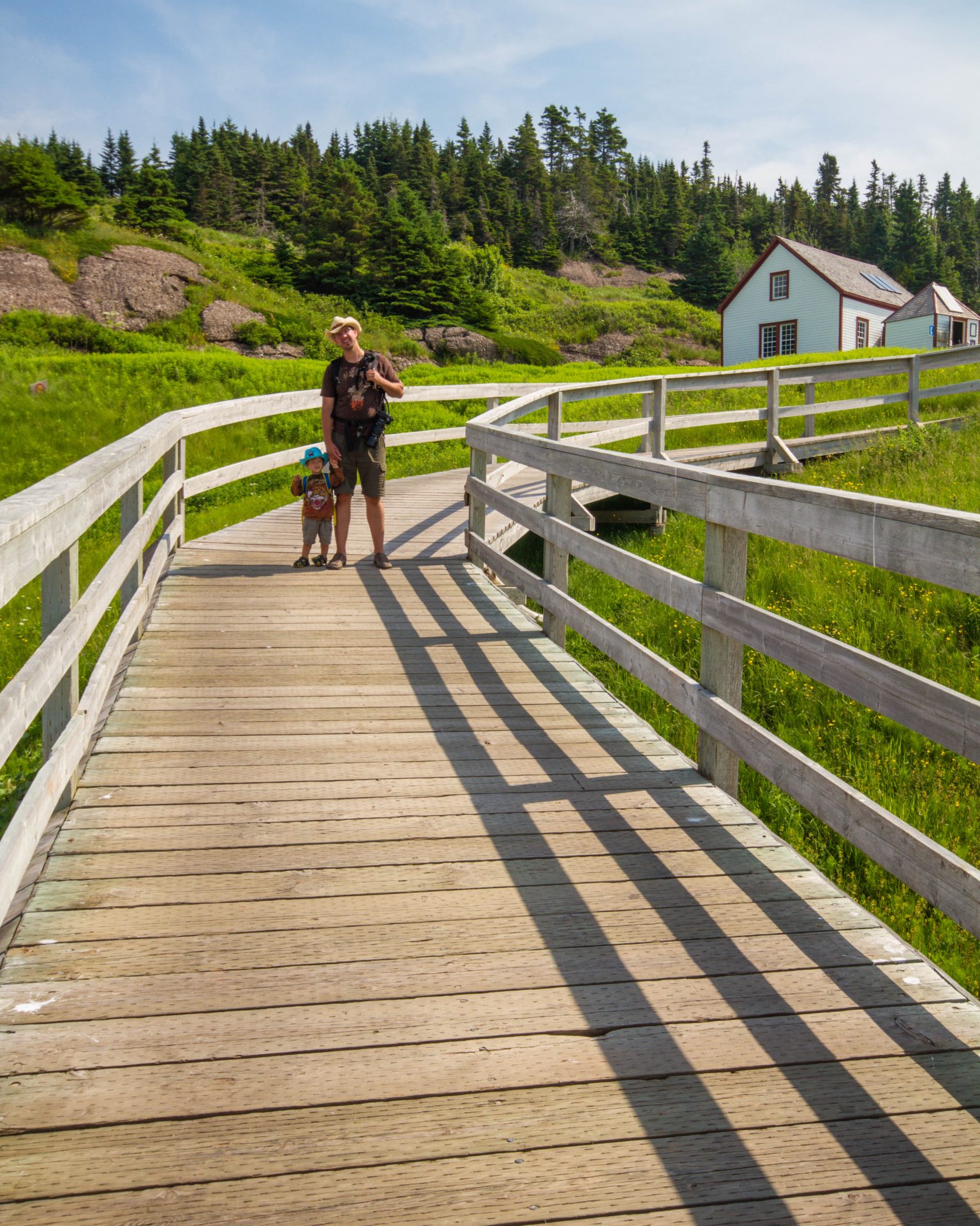 Mom and child walk on the boardwalk on Bonaventure Island in the National Park of Bonaventure Island and Perce Rock