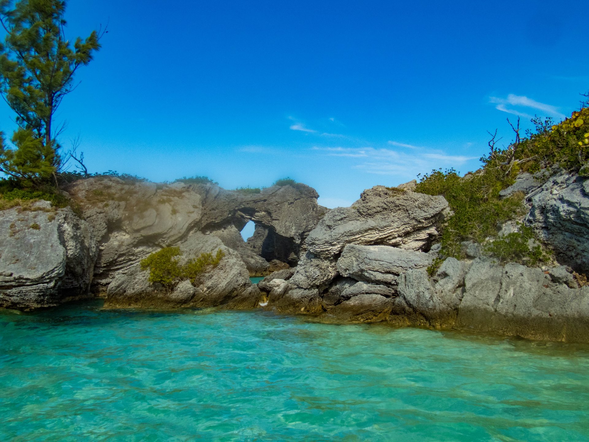 Stunning grey rocks frame emerald blue waters in a Bermuda cove - Boating in Bermuda