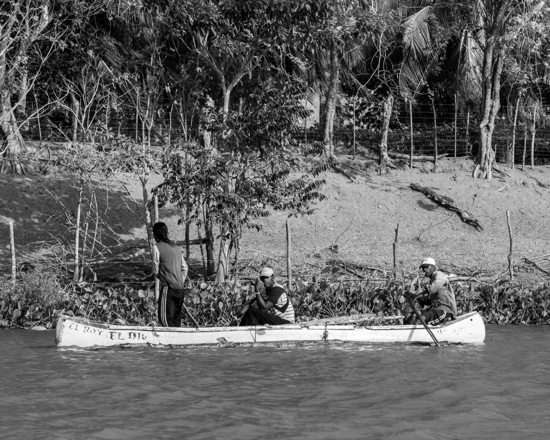 Men on a canoe fishing off of the waters of Pirate Island.