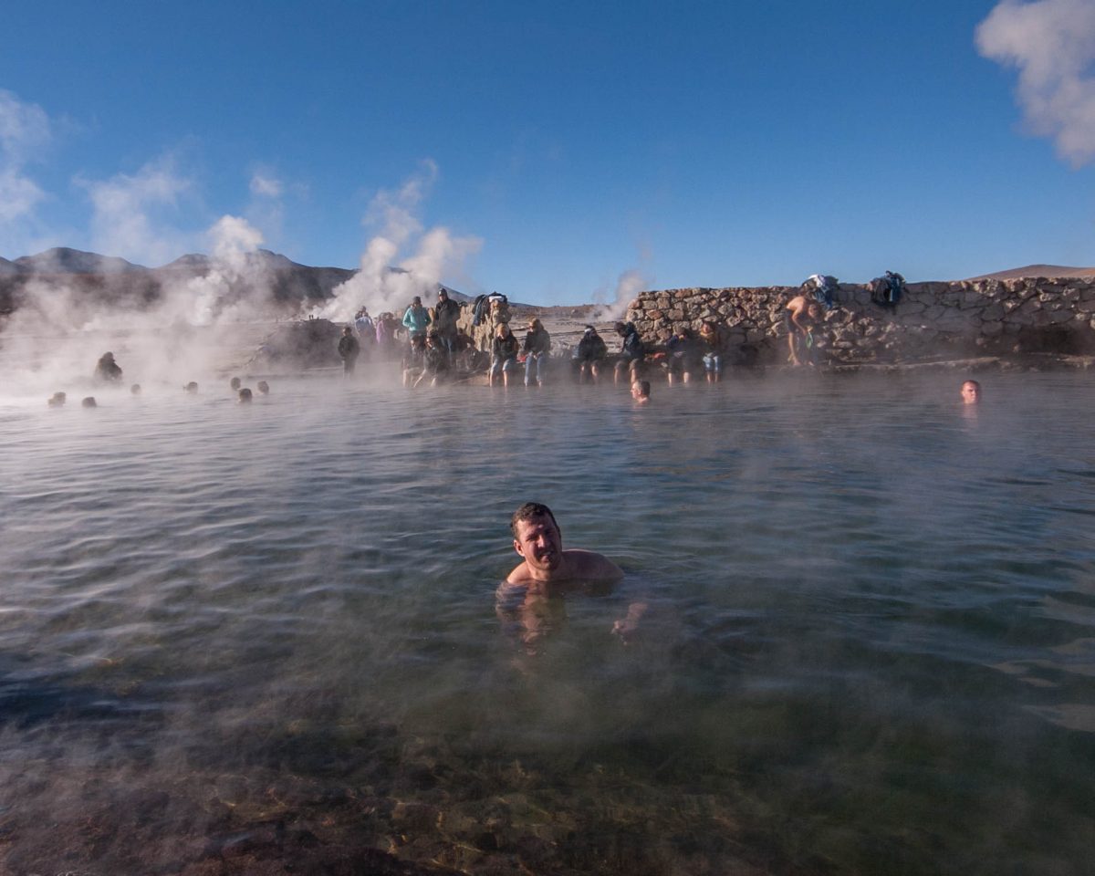Man in natural hot spring in El Tatio Geyser in Chile.
