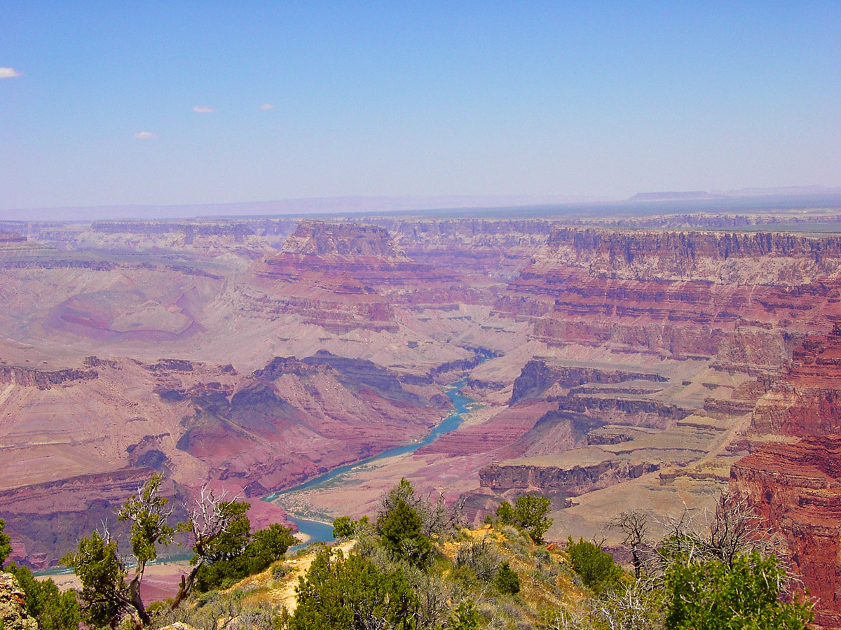 The Colorado river is a shining blue amidst the multi-hued rocks of the Grand Canyon - things to see in the American Southwest