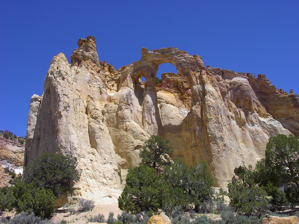 An arch high up in beige cliffs in Grande Escalante National Monument, Utah - things to see in the American Southwest