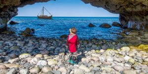 A boy explores the Newfoundland viking trail in Arches Provincial Park