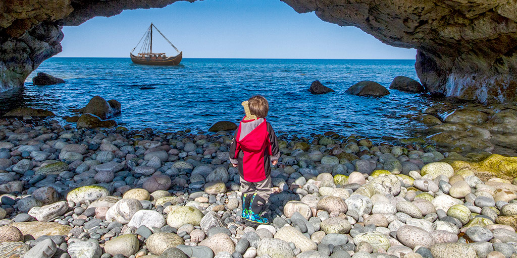 A boy explores the Newfoundland viking trail in Arches Provincial Park