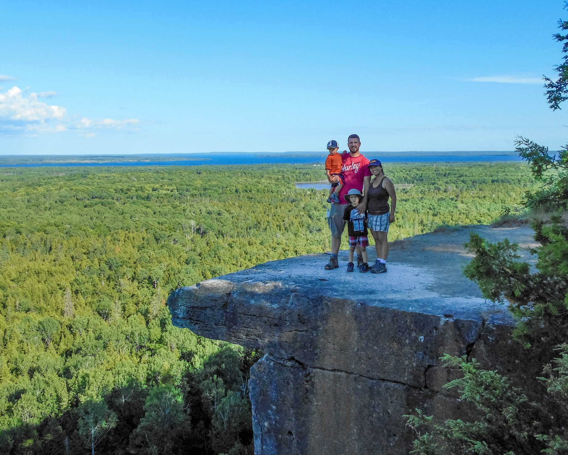 Family picture on the famous lookout at the Cup and Sauce Trail which is one of the Great Spirit Circle Trail Experiences on Manitoulin Island.