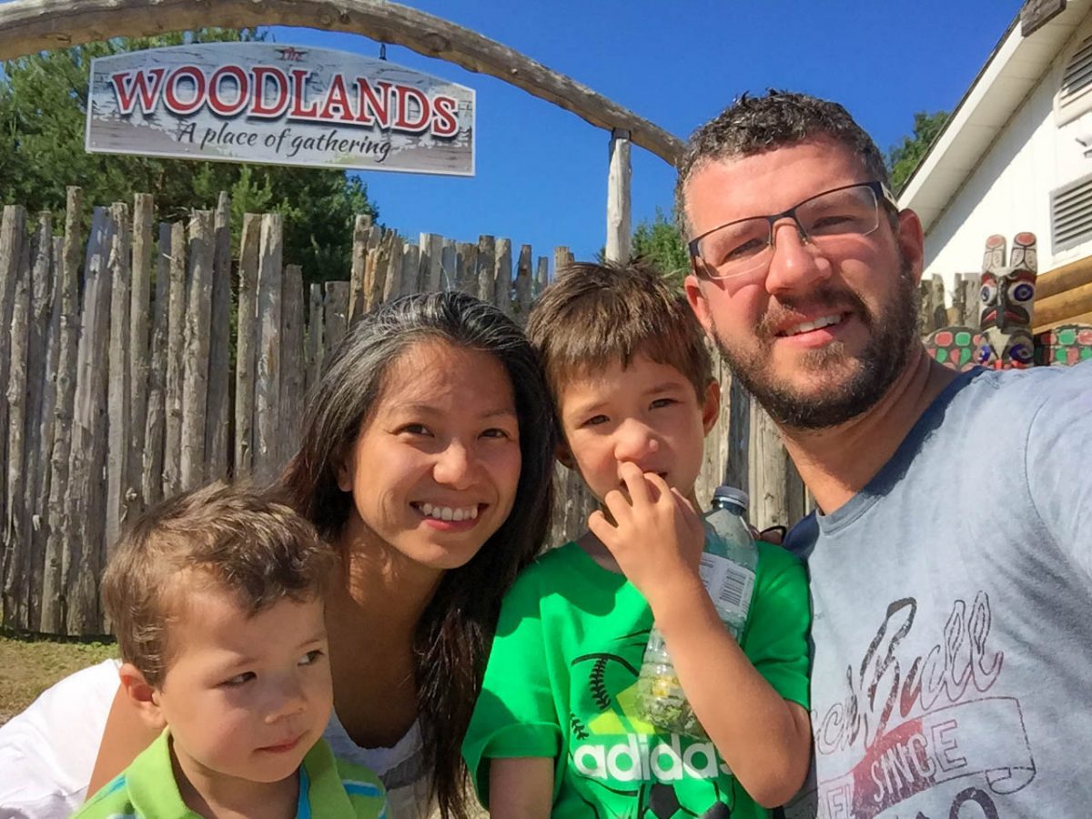 Family poses at the entrance of the glamping campgrounds of the Great Spirit Circle, Manitoulin Island.