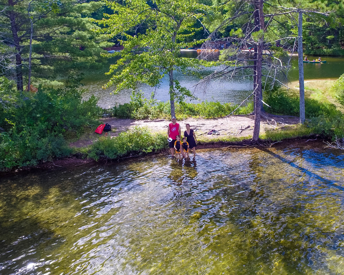 Aerial view of a family smiling at the tip of a lagoon - Top things to do in Bon Echo Provincial Park