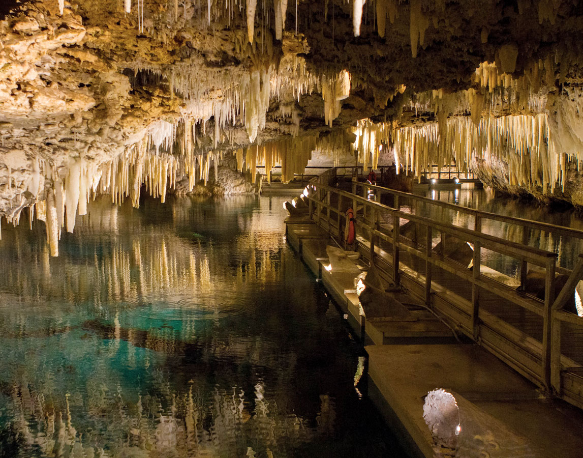 Incredible rock formations hang from the ceiling in Bermudas Crystal Cave - caves you can visit with kids