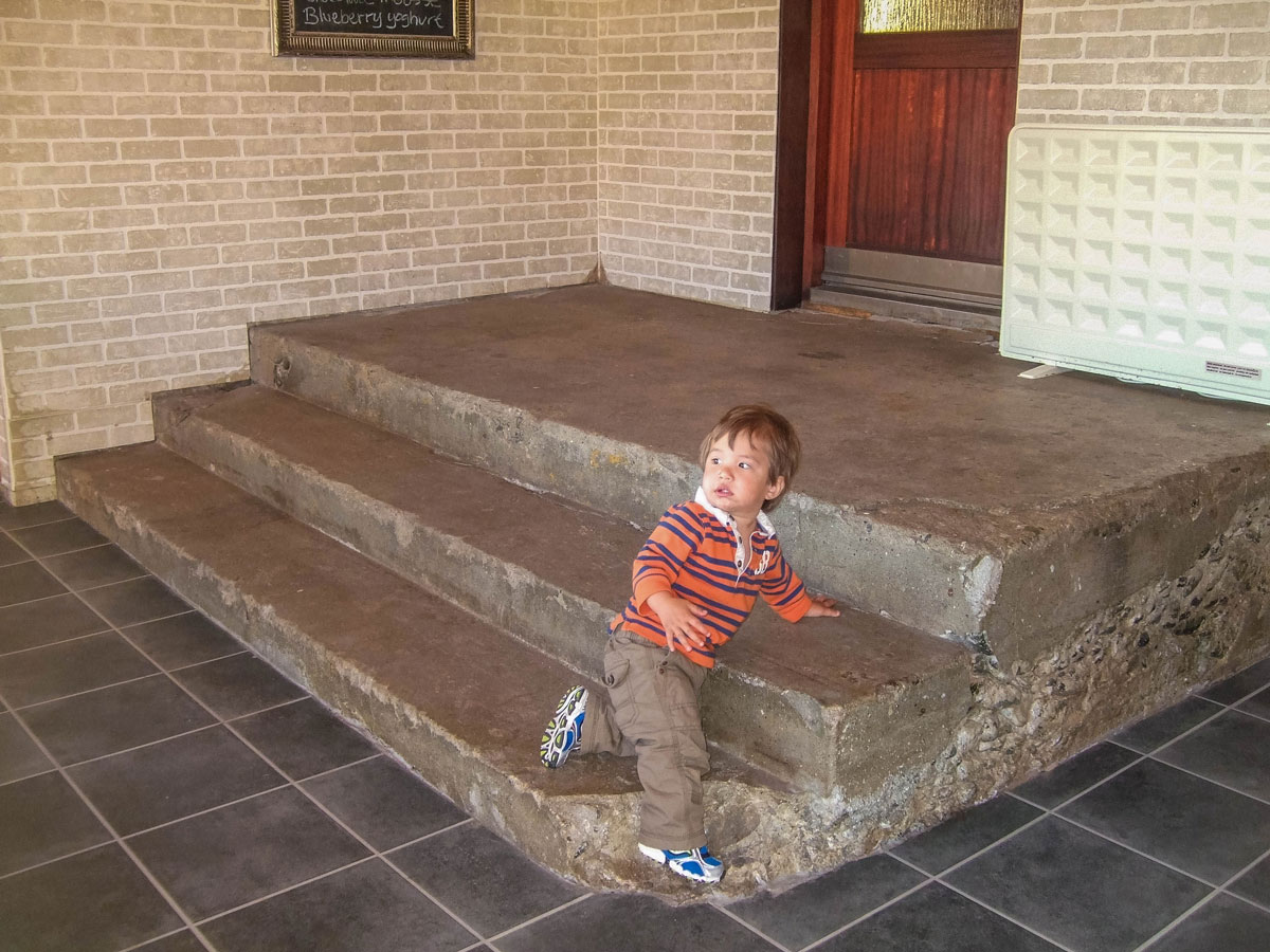 a young boy plays on the stairs of a hotel in Iceland