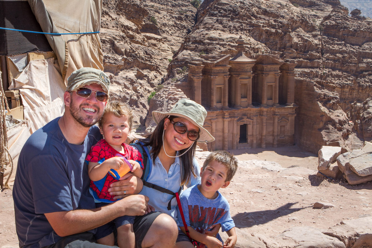 A young family smiling near the Monastery in Petra, Jordan