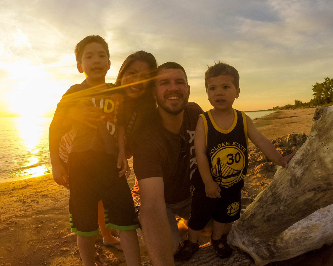 A family poses for a photo at sunset in Sauble Beach Ontario