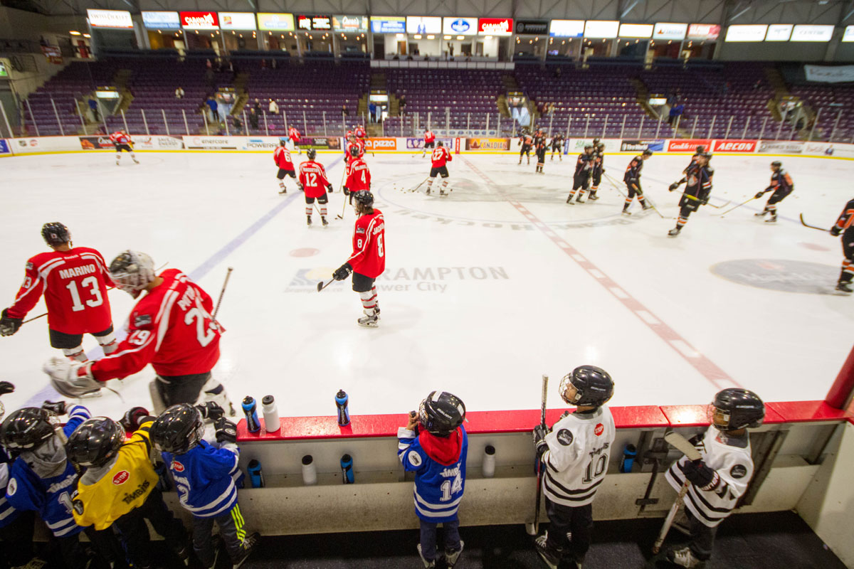a young boy watches the Brampton Beast play from the bench