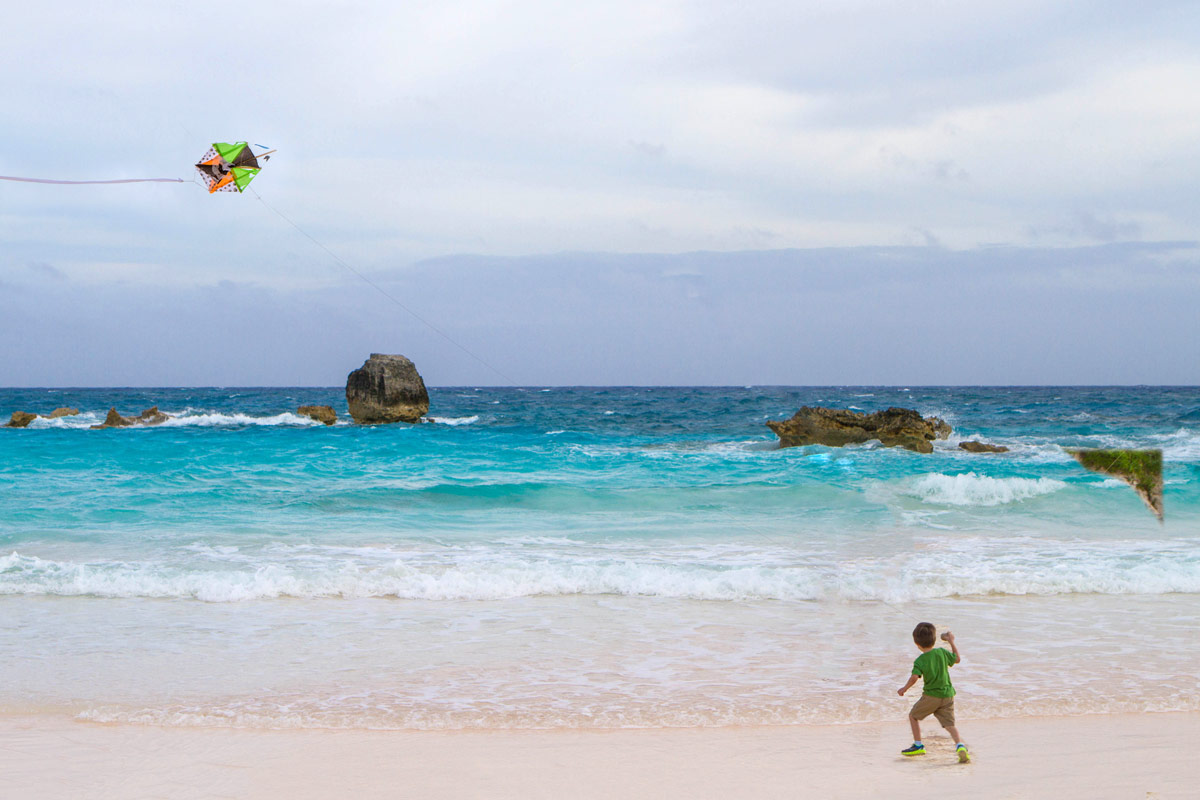 A young boy flies a homemade kite at Horseshoe Bay Beach in Bermuda