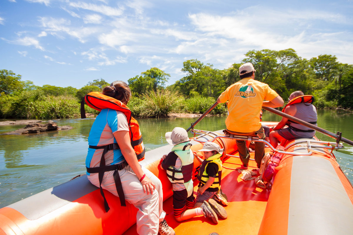 Mother and sons rafting with Iguazu Jungle on Upper Iguazu River on their visit of Iguazu Falls Argentina with kids.