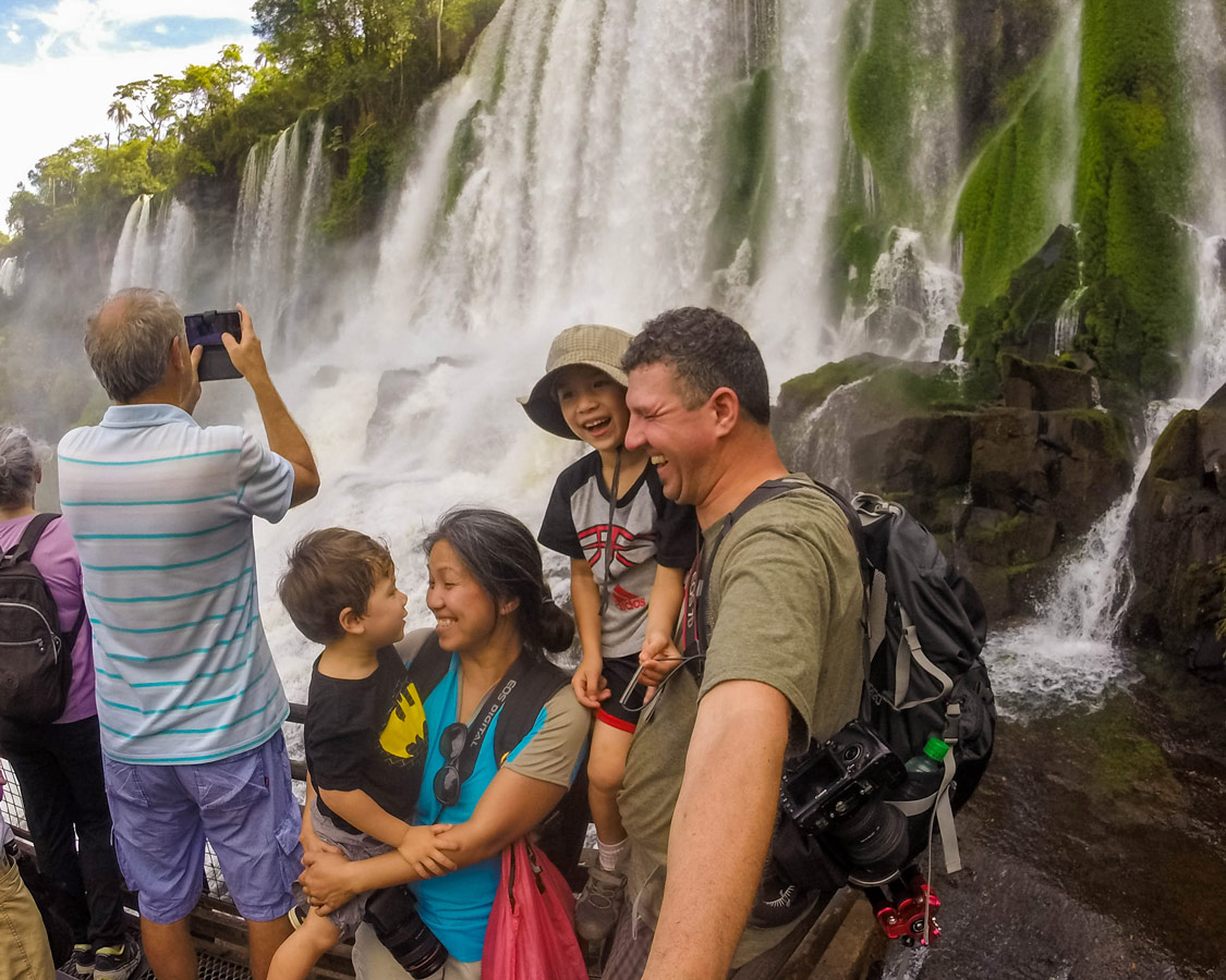 Family with kids gets wet at Salto Bosetti in Iguazu Falls Argentina with kids.