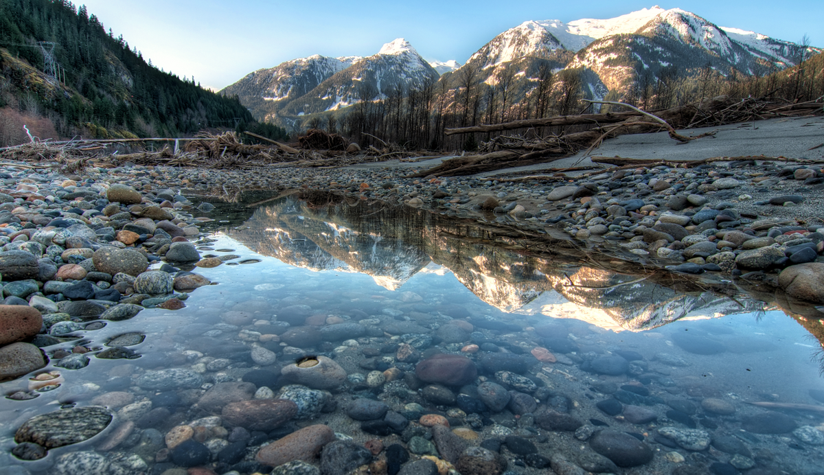 Mountains reflect into a river near Squamish BC on the Sea to Sky Highway one of our Unforgettable Canadian Road Trips