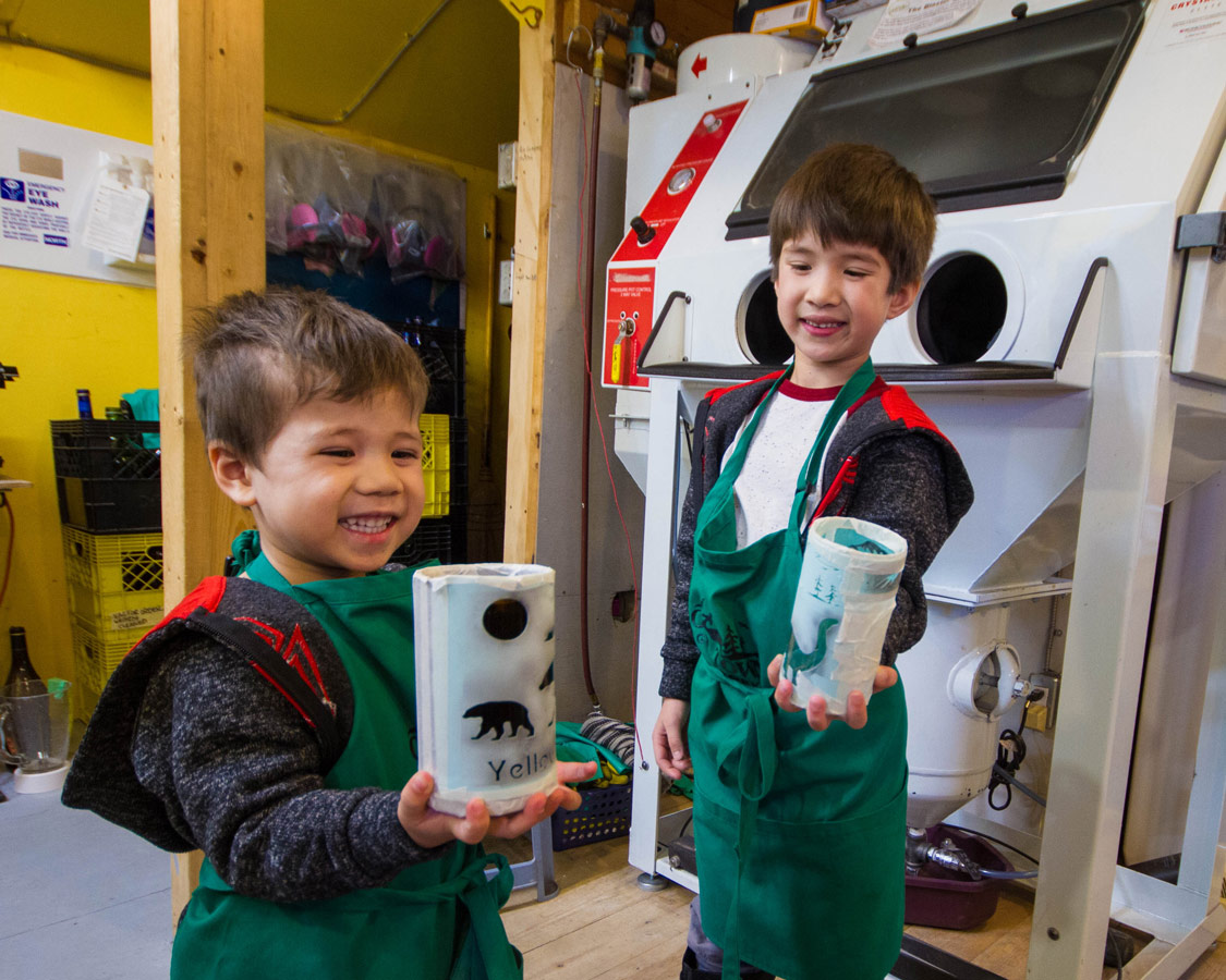 Boys showing off homemade glass.