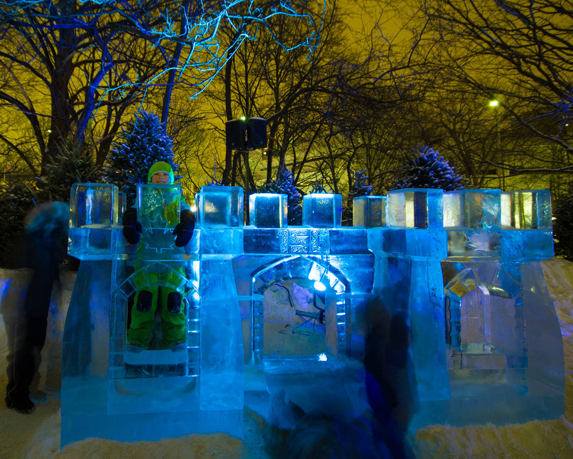 Boy playing in Ice castle is one of the best ways to enjoy Winterlude with kids.