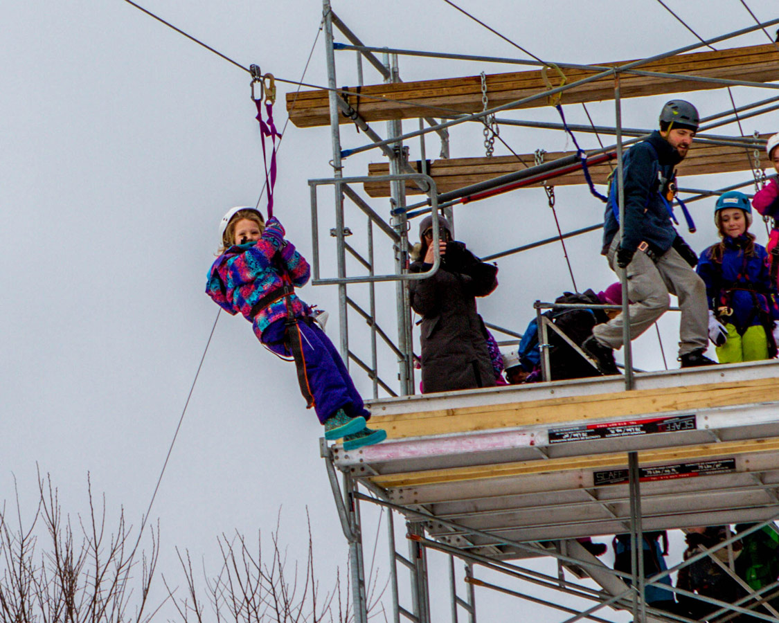 Girl gets ready to go on a zip line.