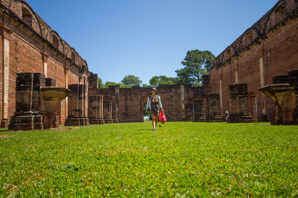 Woman wandering through the ruins of the Jesuit ruins of Jesus de Tavarrangue in Paraguay