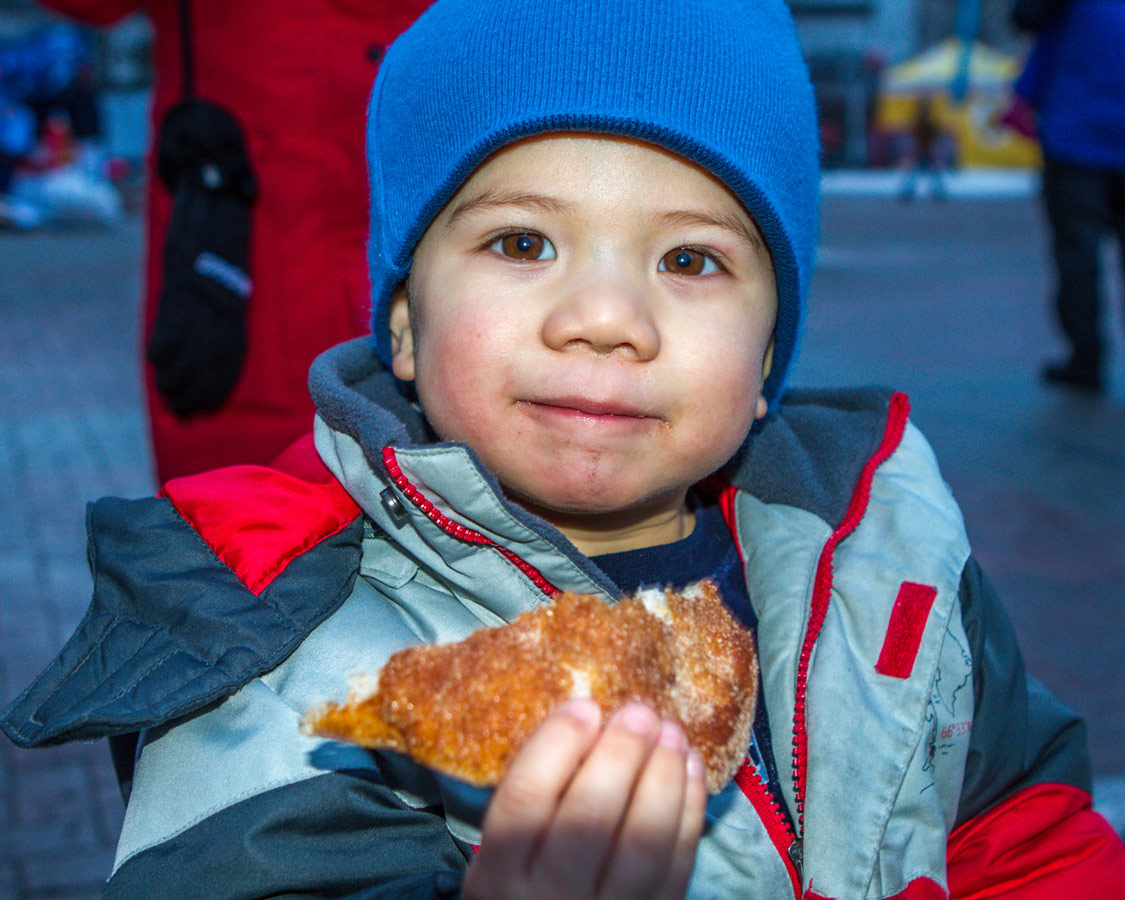 Boy eating a Beaver Tail.