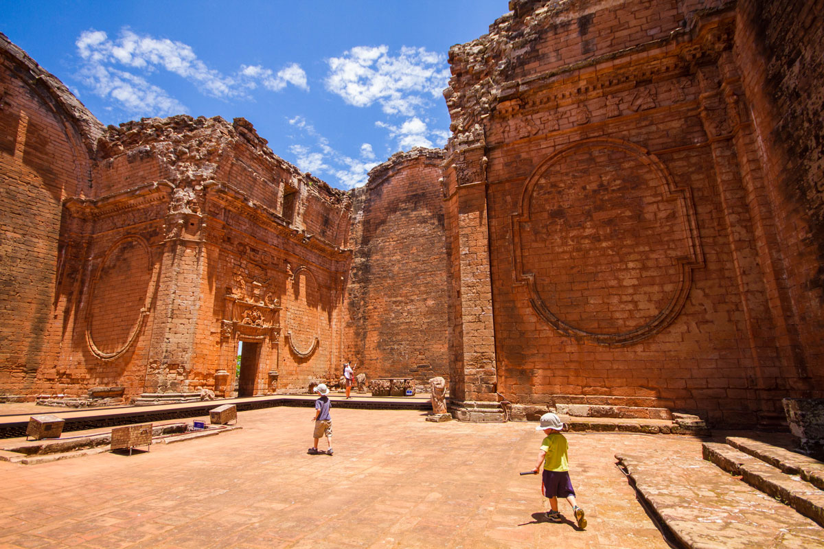 two young boys explore the ruins of the church of Trinidad at the Jesuit ruins in Paraguay